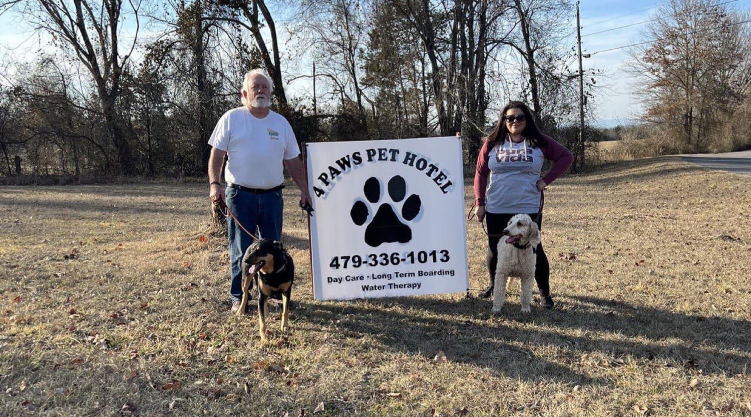The owners of 4 Paws Pet Hotel with their dogs in London, Arkansas